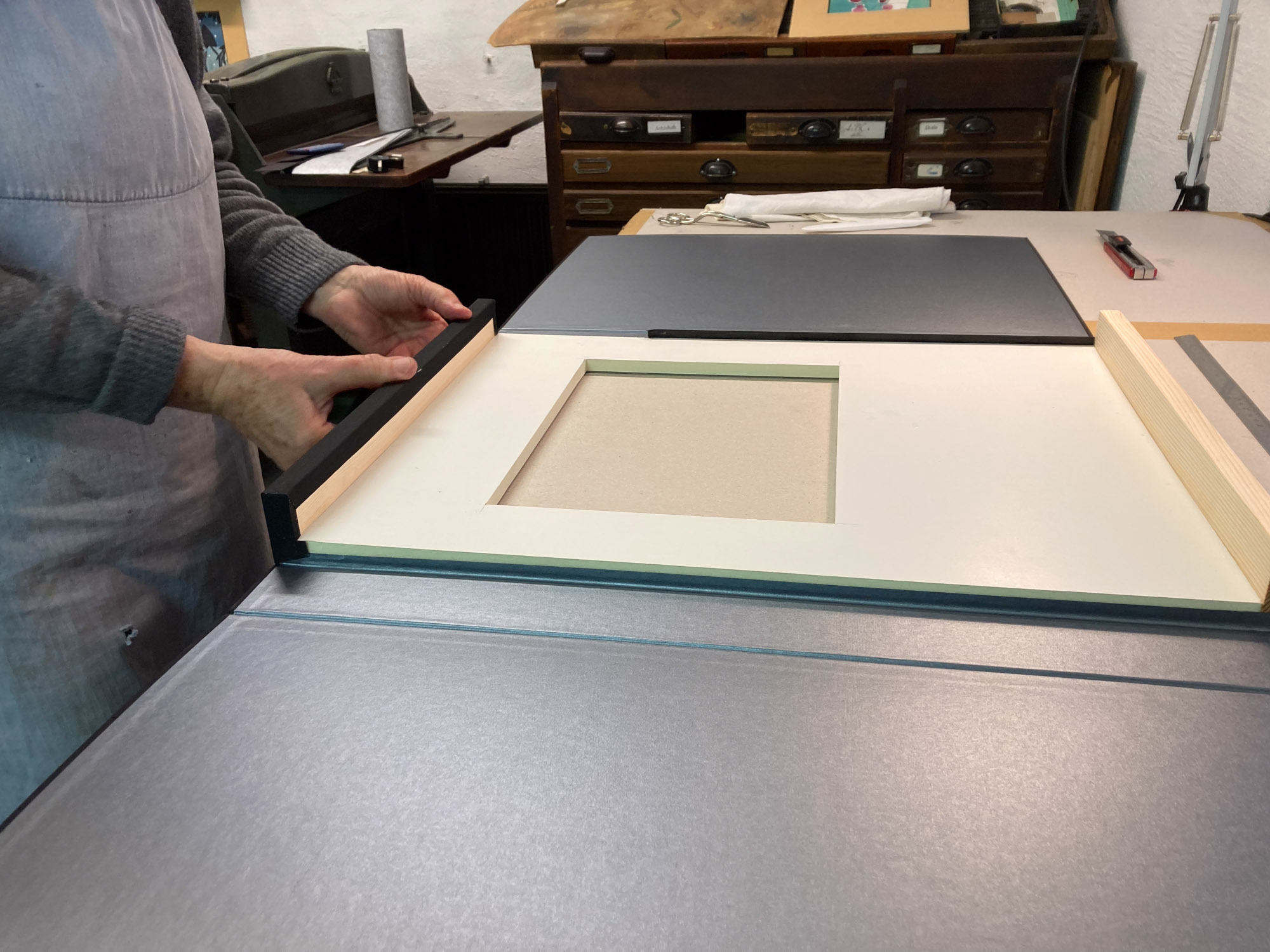 Kassette des Gedichtbandes "Am Sonntag muss ich sterben" von Till Lindemann, während der Fertigung: Die Innenkonstruktion wird in Handarbeit mit Leinen und Buntpapier kaschiert.